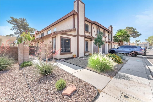 110 Huckleberry Ln, Henderson, NV 89074 - view of front of home featuring a chimney, stucco siding, and a gate