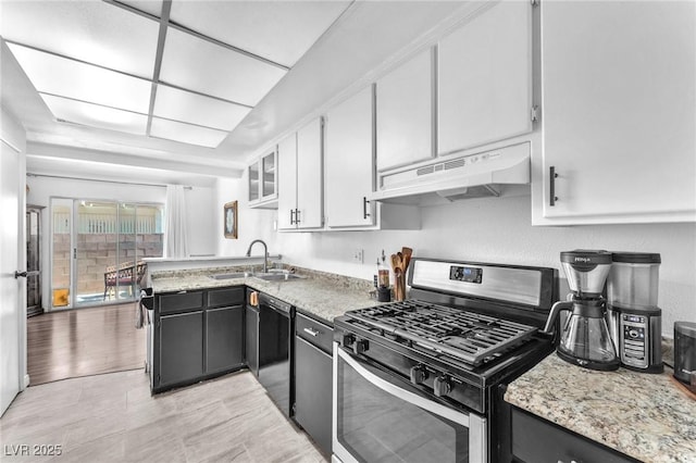 110 Huckleberry Ln, Henderson, NV 89074 - kitchen with gas range, under cabinet range hood, black dishwasher, white cabinets, and a peninsula