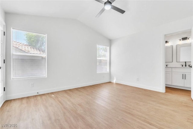 831 Purple Sage Ter, Henderson, NV 89015 - unfurnished bedroom with light wood finished floors, lofted ceiling, connected bathroom, baseboards, and a sink