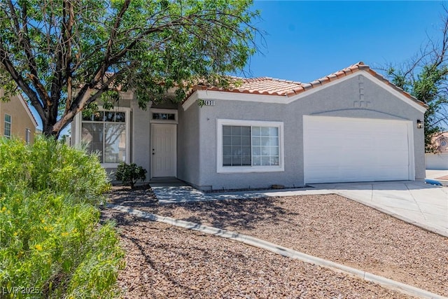 831 Purple Sage Ter, Henderson, NV 89015 - view of front facade featuring stucco siding, driveway, a garage, and a tile roof