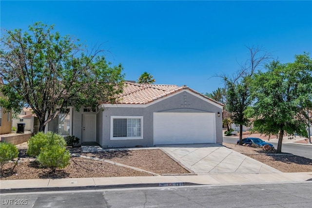 831 Purple Sage Ter, Henderson, NV 89015 - mediterranean / spanish-style home featuring a garage, driveway, stucco siding, and a tile roof