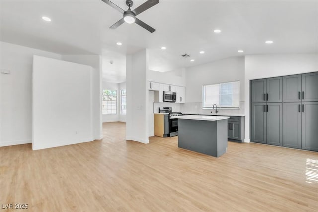 831 Purple Sage Ter, Henderson, NV 89015 - kitchen with appliances with stainless steel finishes, a sink, a center island, light countertops, and recessed lighting