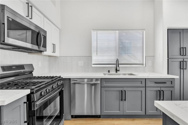 831 Purple Sage Ter, Henderson, NV 89015 - kitchen with stainless steel appliances, a sink, and gray cabinets