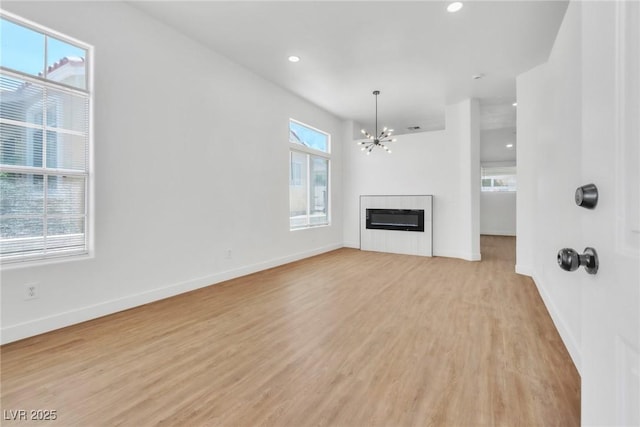 831 Purple Sage Ter, Henderson, NV 89015 - unfurnished living room with a chandelier, light wood finished floors, baseboards, and recessed lighting