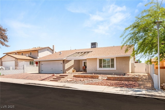 1505 Irene Dr, Boulder City, NV 89005 - ranch-style house with an attached garage, stucco siding, driveway, a gate, and central AC unit