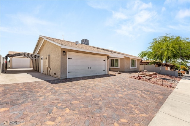 1505 Irene Dr, Boulder City, NV 89005 - ranch-style home with a carport, stucco siding, central AC unit, and driveway