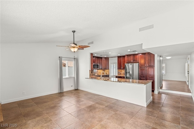 1505 Irene Dr, Boulder City, NV 89005 - kitchen featuring appliances with stainless steel finishes, a peninsula, ceiling fan, a textured ceiling, and baseboards