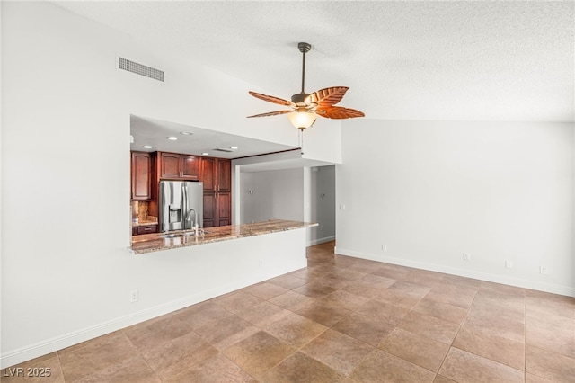 1505 Irene Dr, Boulder City, NV 89005 - unfurnished living room with ceiling fan, baseboards, recessed lighting, a textured ceiling, and bar area