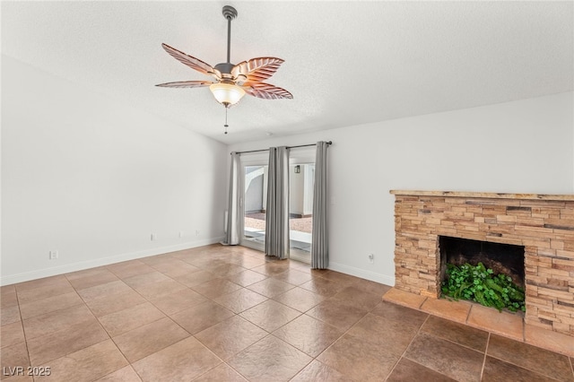 1505 Irene Dr, Boulder City, NV 89005 - unfurnished living room featuring ceiling fan, baseboards, a textured ceiling, tile patterned floors, and a fireplace