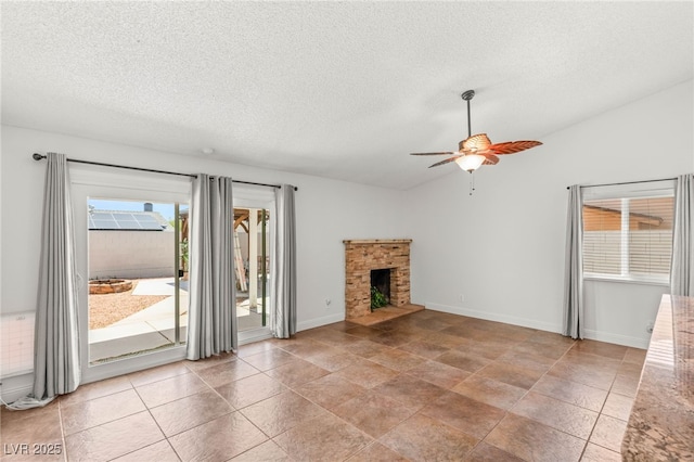 1505 Irene Dr, Boulder City, NV 89005 - unfurnished living room featuring ceiling fan, a textured ceiling, a fireplace with raised hearth, baseboards, and vaulted ceiling