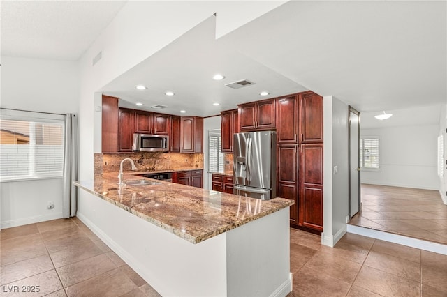1505 Irene Dr, Boulder City, NV 89005 - kitchen featuring stainless steel appliances, light tile patterned floors, a peninsula, a sink, and recessed lighting