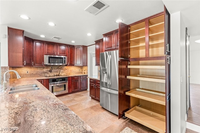 1505 Irene Dr, Boulder City, NV 89005 - kitchen featuring appliances with stainless steel finishes, a sink, light stone countertops, tasteful backsplash, and recessed lighting