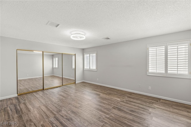 1505 Irene Dr, Boulder City, NV 89005 - unfurnished bedroom featuring wood finished floors, a textured ceiling, a closet, and baseboards