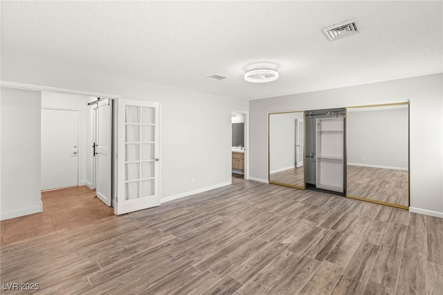 1505 Irene Dr, Boulder City, NV 89005 - unfurnished bedroom featuring wood finished floors, a closet, baseboards, and a textured ceiling