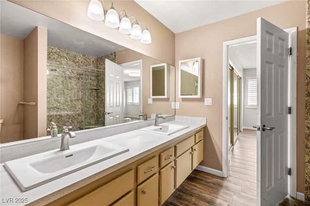 1505 Irene Dr, Boulder City, NV 89005 - full bathroom with a stall shower, double vanity, wood finished floors, and baseboards