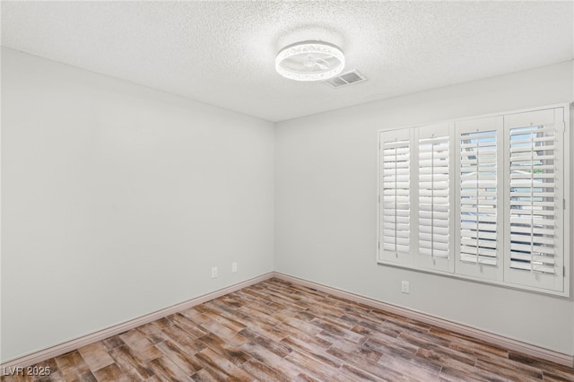 1505 Irene Dr, Boulder City, NV 89005 - unfurnished room with wood finished floors, a textured ceiling, and baseboards
