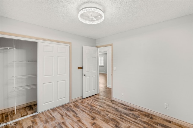 1505 Irene Dr, Boulder City, NV 89005 - unfurnished bedroom with wood finished floors, a closet, a textured ceiling, and baseboards
