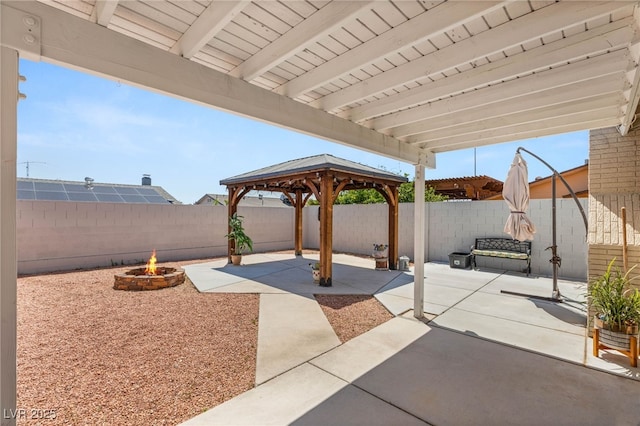 1505 Irene Dr, Boulder City, NV 89005 - fenced backyard with a fire pit, a patio area, and a gazebo