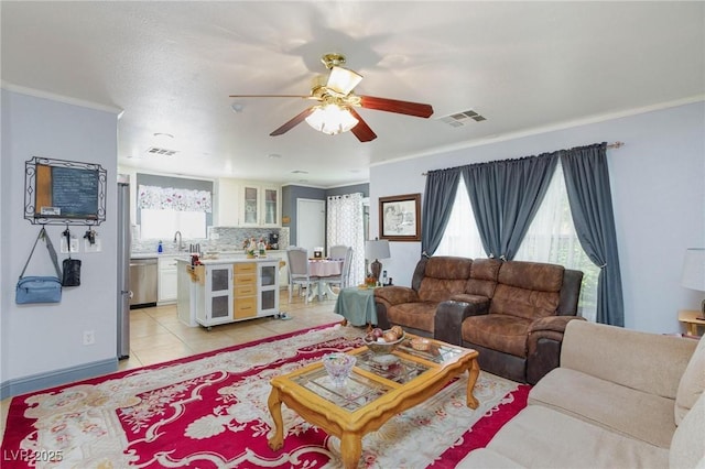 3404 Brayton Mist Dr, North Las Vegas, NV 89081 - living area with crown molding, a ceiling fan, light tile patterned flooring, and baseboards