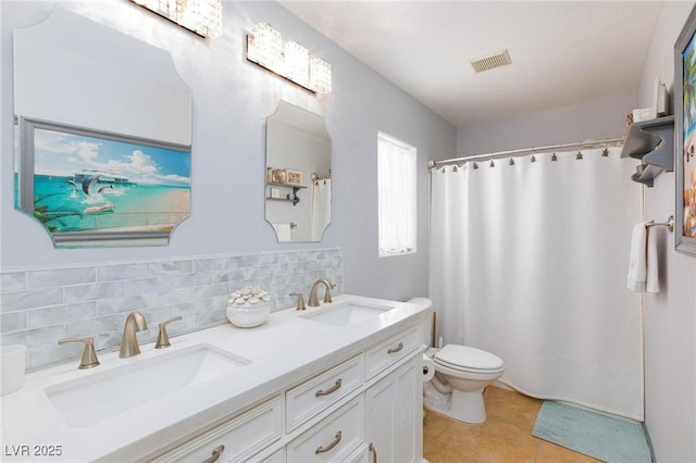 3404 Brayton Mist Dr, North Las Vegas, NV 89081 - full bathroom featuring double vanity, toilet, decorative backsplash, tile patterned flooring, and curtained shower