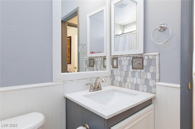 3404 Brayton Mist Dr, North Las Vegas, NV 89081 - bathroom with wainscoting, vanity, toilet, and a textured wall