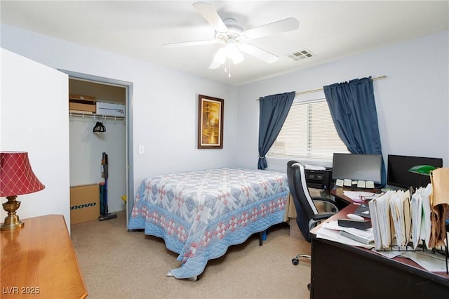 3404 Brayton Mist Dr, North Las Vegas, NV 89081 - bedroom with light colored carpet, an office area, a wall unit AC, a closet, and ceiling fan