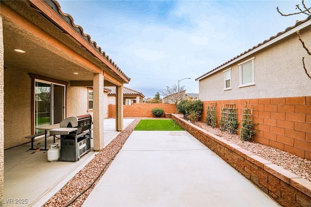766 Topocoba St, Las Vegas, NV 89178 - fenced backyard featuring a grill and a patio