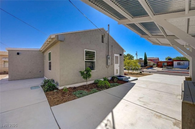 524 Hopi Pl, Boulder City, NV 89005 - view of side of home featuring stucco siding and a patio area