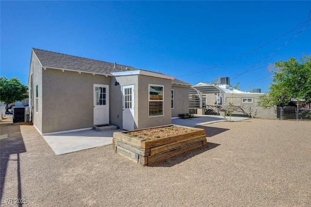 524 Hopi Pl, Boulder City, NV 89005 - rear view of property with stucco siding, a patio area, roof with shingles, and central AC
