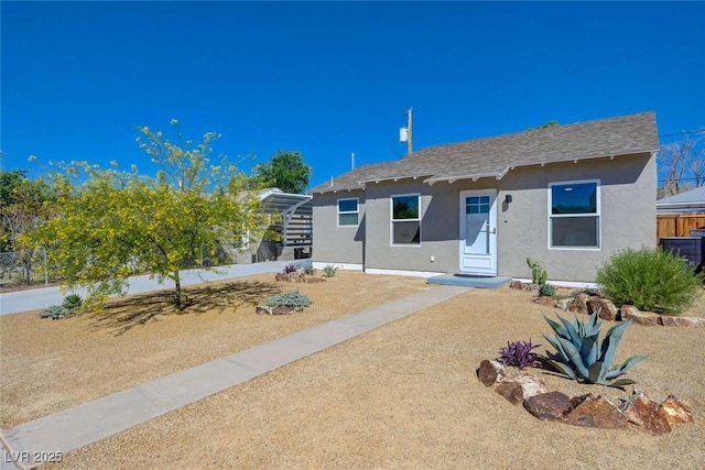 524 Hopi Pl, Boulder City, NV 89005 - view of front of property with stucco siding, a shingled roof, and central AC unit
