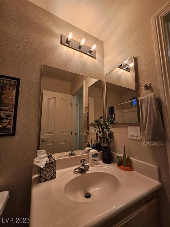 2077 Alki Beach Ave, Laughlin, NV 89029 - bathroom with a textured wall, vanity, and toilet