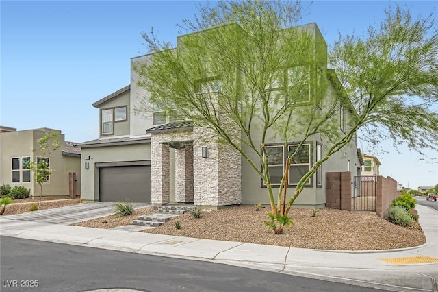 6830 Fallen Rock St, North Las Vegas, NV 89084 - view of front facade featuring a garage, stucco siding, driveway, and a gate