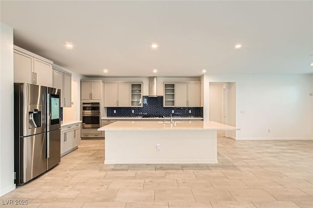 6830 Fallen Rock St, North Las Vegas, NV 89084 - kitchen with stainless steel appliances, a sink, light countertops, gray cabinets, and a center island with sink