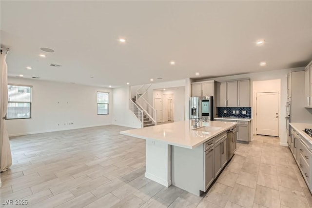 6830 Fallen Rock St, North Las Vegas, NV 89084 - kitchen with gray cabinetry, a sink, appliances with stainless steel finishes, light countertops, and recessed lighting