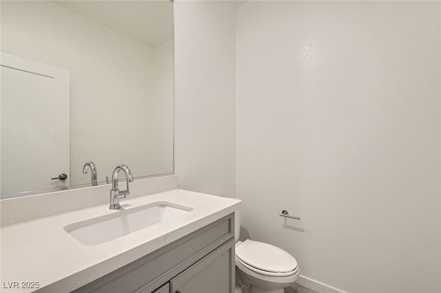 6830 Fallen Rock St, North Las Vegas, NV 89084 - half bathroom featuring vanity, toilet, and baseboards