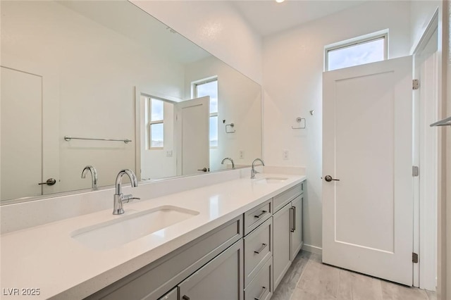 6830 Fallen Rock St, North Las Vegas, NV 89084 - bathroom featuring double vanity and plenty of natural light