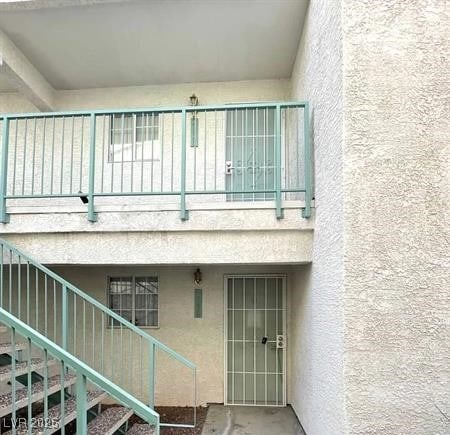 2725 S Nellis Blvd Unit 1158, Las Vegas, NV 89121 - view of exterior entry featuring stucco siding and a balcony