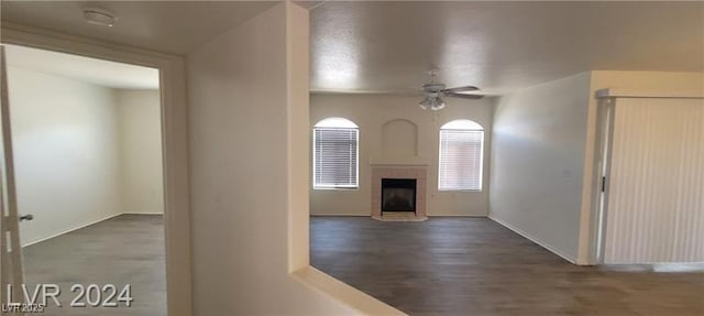 4555 Sahara Ave Unit 252, Las Vegas, NV 89104 - unfurnished living room with a ceiling fan, a fireplace, baseboards, and wood finished floors