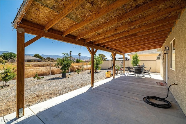 100 Eton St, Pahrump, NV 89048 - fenced backyard featuring a patio, a mountain view, and outdoor dining space