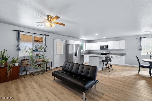 100 Eton St, Pahrump, NV 89048 - living area with light wood-type flooring, a ceiling fan, recessed lighting, and a textured ceiling