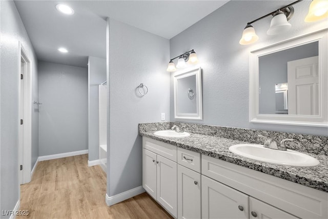 100 Eton St, Pahrump, NV 89048 - bathroom featuring double vanity, wood finished floors, shower / bath combo with shower curtain, and recessed lighting