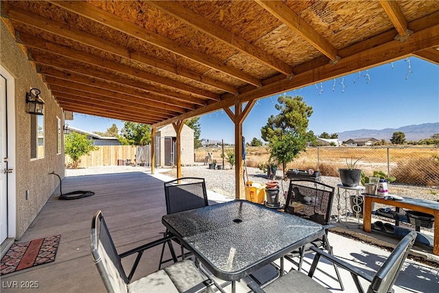 100 Eton St, Pahrump, NV 89048 - fenced backyard featuring a storage unit, outdoor dining space, and a deck with mountain view