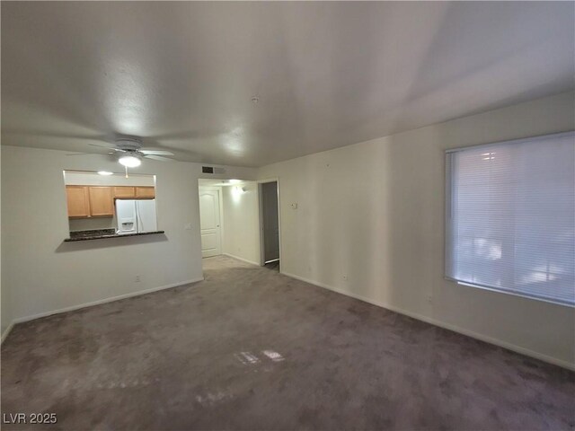 7730 Secret Shore Dr Unit 207, Las Vegas, NV 89128 - unfurnished living room featuring a ceiling fan, carpet, and baseboards