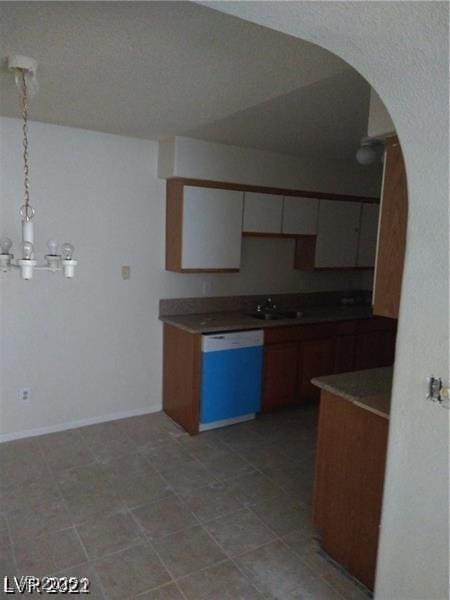 1608 N Torrey Pines Dr Unit 103, Las Vegas, NV 89108 - kitchen featuring dishwasher, arched walkways, a chandelier, hanging light fixtures, and a sink