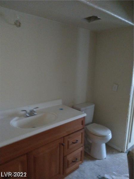 1608 N Torrey Pines Dr Unit 103, Las Vegas, NV 89108 - bathroom featuring vanity, toilet, and tile patterned flooring
