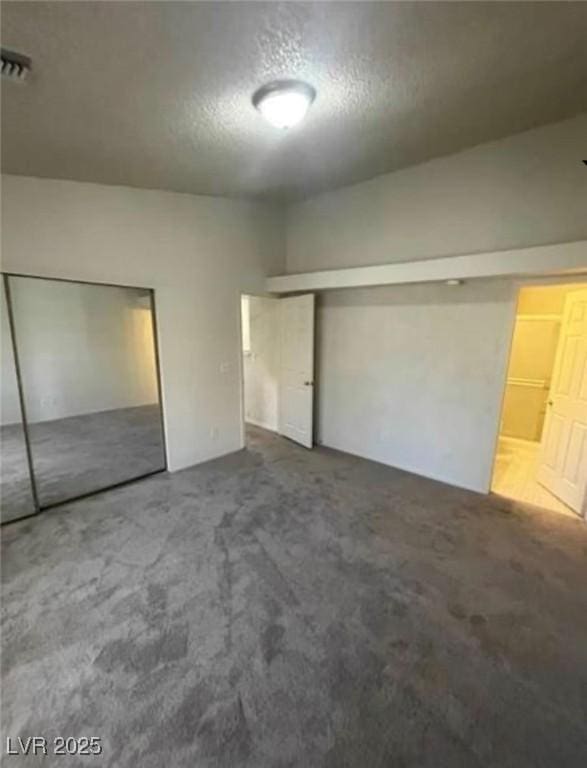 2995 E Sunset Rd Unit 237, Las Vegas, NV 89120 - unfurnished bedroom featuring carpet, a textured ceiling, and a closet
