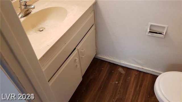 1336 N Jones Blvd, Las Vegas, NV 89108 - half bath featuring vanity, toilet, and wood finished floors