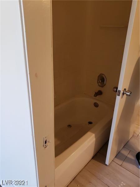 4231 White Sands Ave, Las Vegas, NV 89121 - bathroom with wood finished floors and shower / tub combination