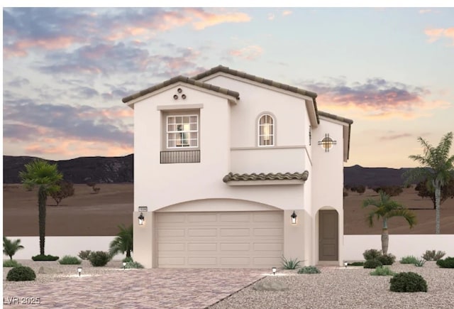 887 Arbor Spring St, Henderson, NV 89011 - mediterranean / spanish-style home with a garage, stucco siding, driveway, a tiled roof, and a mountain view