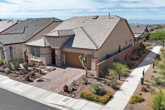 3096 Beaux Art Ave, Henderson, NV 89044 - view of front facade with stucco siding, a garage, decorative driveway, and stone siding